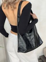 Sac noir porté sur l’épaule avec veste oversize